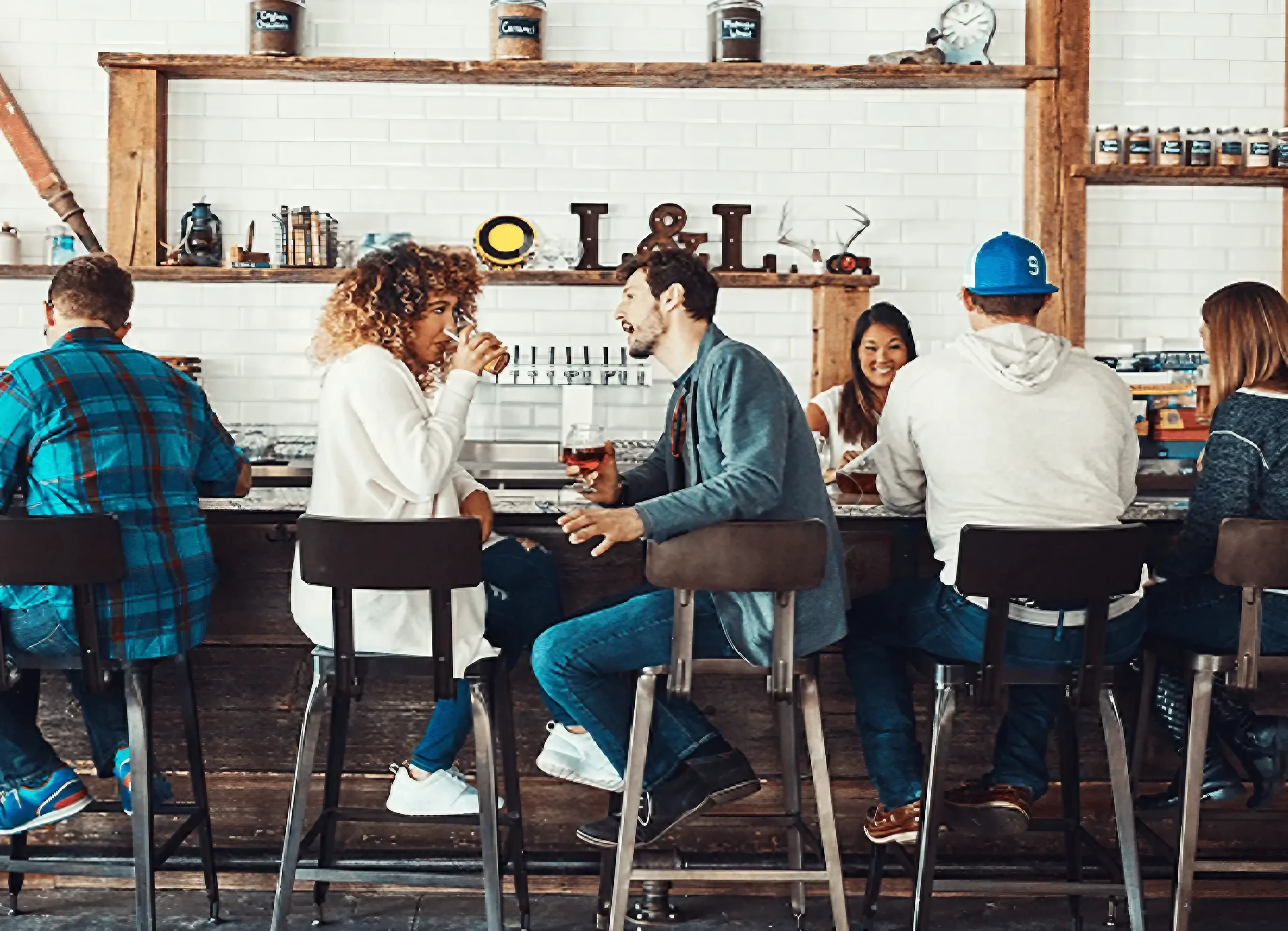 Friends enjoying drinks at a lively bar.